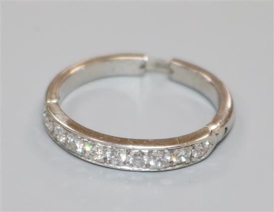 A white metal and nine stone diamond half eternity ring, with extendable shank, size L-Q